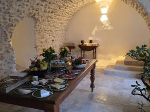 a table with plates of food on it in a room at Bastide Hedone en Luberon in Apt