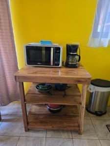 a microwave sitting on top of a wooden table at Rusticas Dani in Tanque