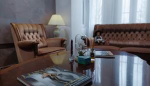 a living room with a table and a couch at Vila Rapsodia Sinaia in Sinaia