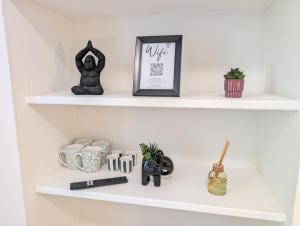 a white shelf with some items on it at Le Studio Évasion Tropicale in Quimper