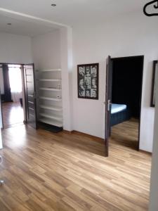 an empty room with a bed and a wooden floor at TG Krakowska Kamienica in Tarnowskie Góry