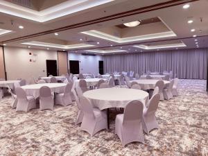 a banquet hall with white tables and white chairs at Ramada by Wyndham Tukwila Southcenter in Tukwila +35 photos
