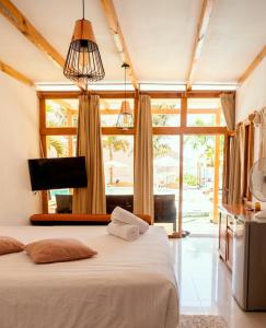 a bedroom with a bed and a large window at Sababa Resort in San Pedro La Laguna