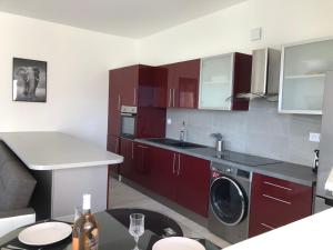 a kitchen with red cabinets and a washer at French Riviera near Nice Monaco, Apartments in Villa, Sea Montain View in Carros +71 photos