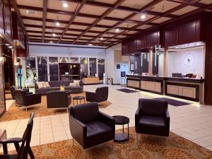 a lobby with couches and chairs in a room at Ramada by Wyndham Tukwila Southcenter in Tukwila