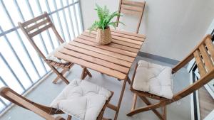 a wooden table with two chairs and a potted plant at The Eight Element Suites & Lofts in Madrid