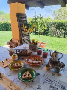 a table with plates of food on top of it at Starsbox Le Moline B&B in Masserano