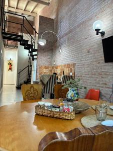 a dining room with a table and a brick wall at Duplex Las Margaritas Bosque Peralta Ramos in Mar del Plata