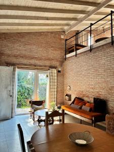 a living room with a couch and a table at Duplex Las Margaritas Bosque Peralta Ramos in Mar del Plata