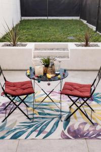 a table and two chairs on a patio at Studio du port avec jardin privé in Saint-André-de-Cubzac