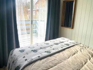 a bed in a room with a window at 4 star holiday home in SÖLVESBORG in Sölvesborg