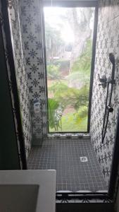 a door leading to a bathroom with a bike outside at Pond Cottage in Knysna