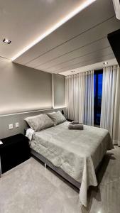a bedroom with a large bed and a large window at Apartamento de Luxo 2 Quartos, Brasília - Get Park Sul - com Garagem in Brasília +32 photos