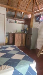 a kitchen with a refrigerator and a tiled floor at Coconut Surf in El Gigante