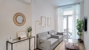 a living room with a couch and a glass table at The Eight Element Suites & Lofts in Madrid