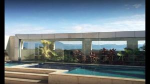 a building with a swimming pool in front of it at Aparthotel diamond flat in Nova Iguaçu