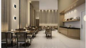 a restaurant with tables and chairs and a bar at Aparthotel diamond flat in Nova Iguaçu