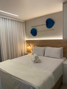 a bedroom with a large white bed with towels on it at Sunny Hall Porto de Galinhas PE - Flat Piscina Privativa in Porto De Galinhas +42 photos