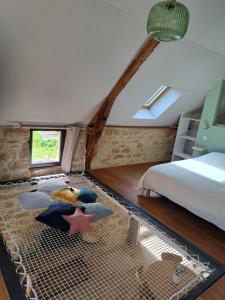 a bedroom with a bed and a bird cage at Instant Lot Maison pierre insolite Piscine Nature in Strenquels +21 photos
