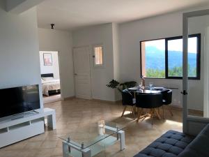 a living room with a table and a television at French Riviera near Nice Monaco, Apartments in Villa, Sea Montain View in Carros