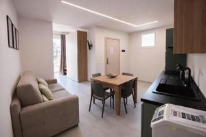 a living room with a couch and a table at Davs Home Appartamento per 4 a Lentini con WiFi Self Check in in Lentini +8 photos
