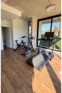 a gym with two exercise bikes and a laptop at Seaside Piriápolis apartamento 105 in Piriápolis