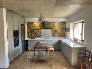 a kitchen with a table and chairs in a room at La casa de Cabuérniga in Cabuerniga