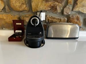 a black iron sitting on a counter next to a toaster at La casa de Cabuérniga in Cabuerniga +20 photos
