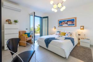 a bedroom with a bed and a desk and a chair at Luxury Sunshine Villa in Alghero with pool and sea view in Alghero +64 photos
