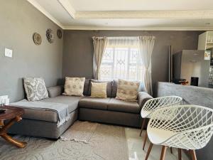 a living room with a couch and a table at The Valley View Nest in Ezulwini