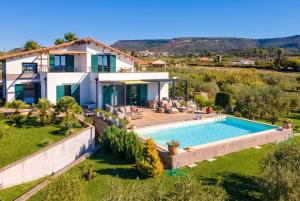 an aerial view of a house with a swimming pool at Luxury Sunshine Villa in Alghero with pool and sea view in Alghero