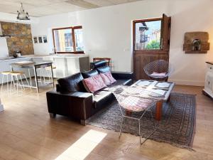 a living room with a couch and a table at La casa de Cabuérniga in Cabuerniga