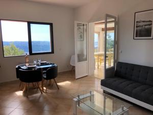 a living room with a black couch and a table at French Riviera near Nice Monaco, Apartments in Villa, Sea Montain View in Carros