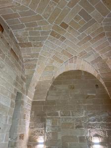 an archway in a brick building with lights on it at Petra dimora leccese in Lecce