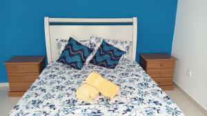a bed with two pillows and a yellow towel on it at Ka'Zinha Guesthouse - Chambres d'hôtes Tarrafal in Tarrafal
