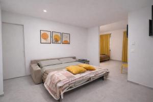 a bedroom with a bed with yellow pillows on it at Davs Home Appartamento per 4 a Lentini con WiFi Self Check in in Lentini
