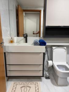 a bathroom with a white sink and a toilet at JUPET Studio in Brasília +28 photos