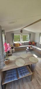 a living room with a couch and a table at Sunny Haven in Skegness