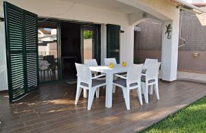 a white table and chairs on a patio at Roda Bruc, casa con piscina privada! in Roda de Bará