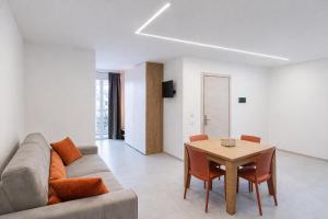 a living room with a couch and a table at Davs Home Appartamento per 4 a Lentini con WiFi Self Check in in Lentini