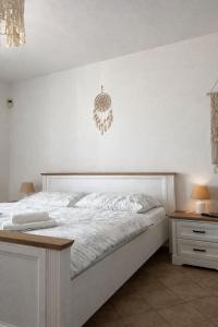 a bedroom with a bed with a chandelier on the wall at Penzion Cizku u Trebone in Třeboň