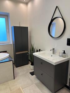a bathroom with a sink and a mirror on the wall at Auszeit nahe Freizeitpark in Grethem