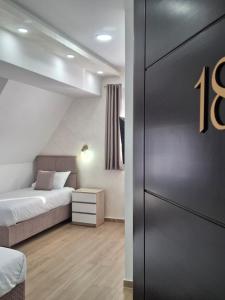 a bedroom with a bed and a door with the number at Srebrna Jela in Žabljak