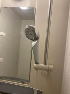 a hair dryer in front of a mirror at ReFa room由来House in Kumamoto