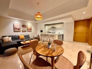 a living room with a couch and a table and chairs at Modern and cozy CFC apartment in Casablanca