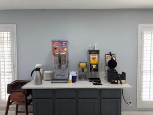a kitchen counter with a counter top with a coffee maker at Days Inn by Wyndham Granbury in Granbury