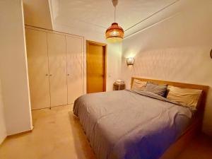 a bedroom with a bed and a pendant light at Modern and cozy CFC apartment in Casablanca +4 photos