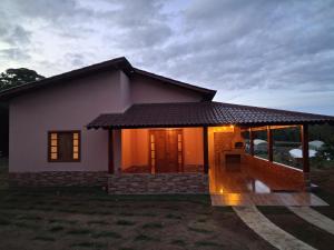 a small house with a lit up front of it at Cottage Saint Antoine in Pedra Azul