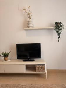 a flat screen tv sitting on top of a table at Casa Sol Serena - Pool, Beach & Golf in Los Alcázares