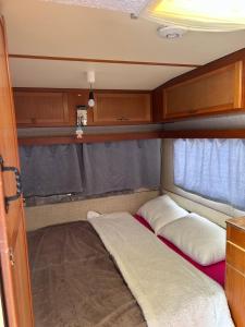 a small room with two beds in the back of an rv at A little paradise 2 in Radanovići